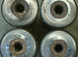 Abrasive wear of tapered bearing rollers resulting from contamination