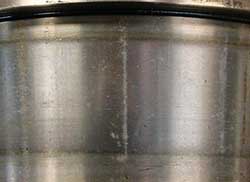 False brinelling at roller spacing on a tapered roller bearing cone.