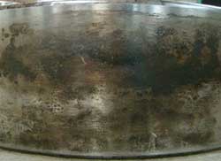 Fretting corrosion on the outer diameter of a cylindrical bearing.