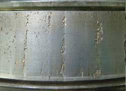 Contact fatigue spalling on a cone raceway resulting from impact damage (brinelling).