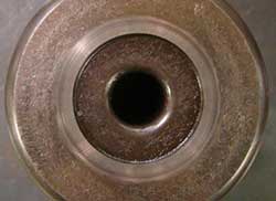 Smearing wear on a tapered bearing roller resulting from insufficient lubrication