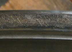 Smearing wear on a tapered bearing cone thrust flange resulting from an insufficient lubricant film